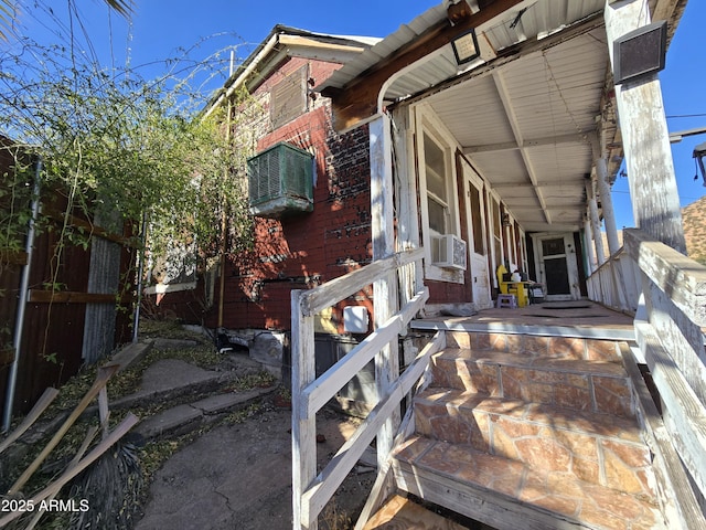 exterior space with cooling unit and brick siding