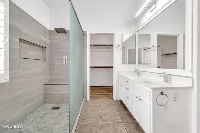 3044 E Sparrow Pl, Chandler, AZ 85286 - bathroom featuring double vanity, a sink, a walk in closet, and a tile shower