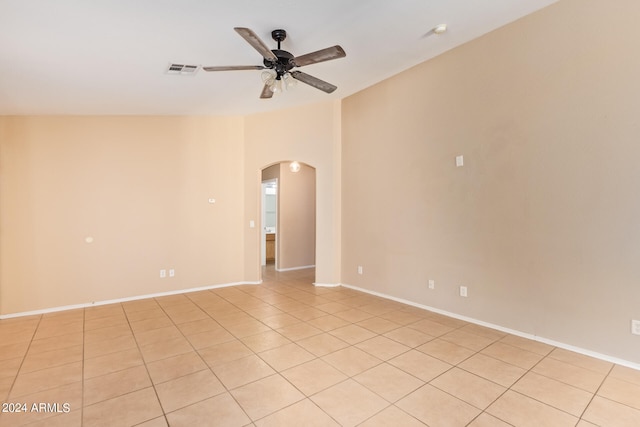 tiled spare room featuring ceiling fan and lofted ceiling