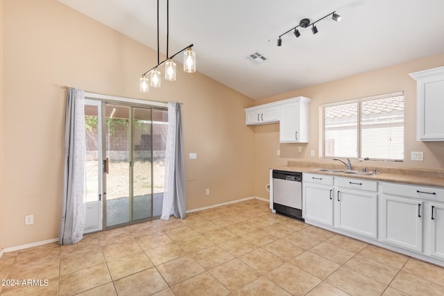 kitchen featuring light tile patterned flooring, lofted ceiling, white dishwasher, track lighting, and decorative light fixtures