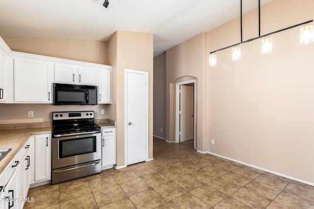 kitchen featuring white cabinetry, decorative light fixtures, light tile patterned flooring, and electric stove