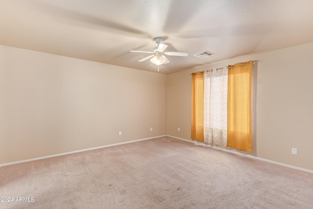 spare room featuring carpet and ceiling fan