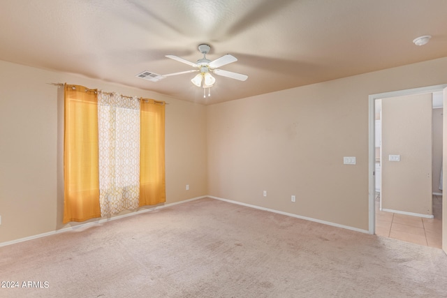 empty room featuring carpet floors and ceiling fan