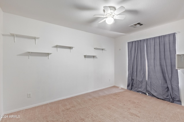 spare room with carpet and ceiling fan