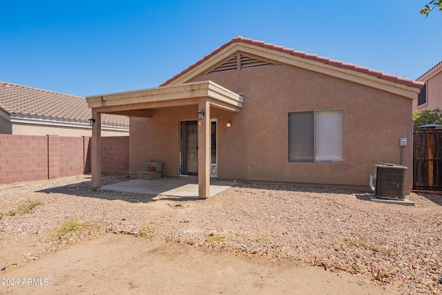 back of property with a patio area and cooling unit