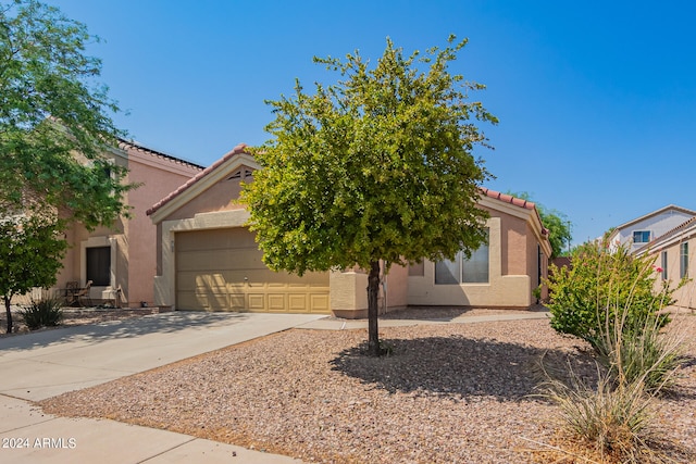 view of property hidden behind natural elements with a garage