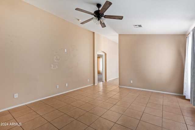 unfurnished room with light tile patterned flooring, lofted ceiling, and ceiling fan