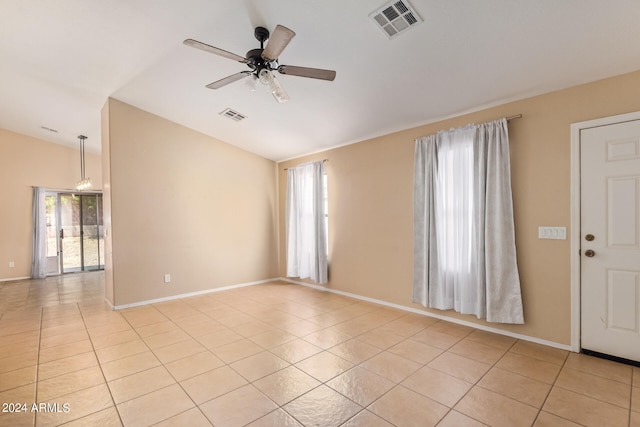 tiled empty room featuring ceiling fan