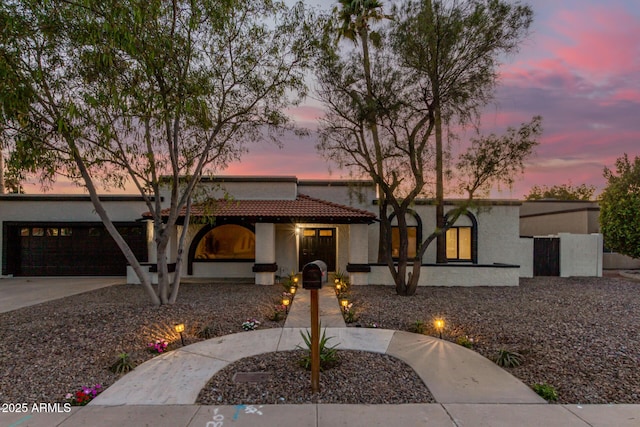 1736 N Ashbrook Cir, Mesa, AZ 85213 - mediterranean / spanish home featuring a garage, stucco siding, driveway, and a tiled roof