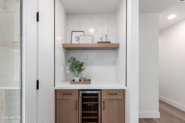 1736 N Ashbrook Cir, Mesa, AZ 85213 - indoor dry bar with beverage cooler, light wood-style flooring, backsplash, baseboards, and recessed lighting