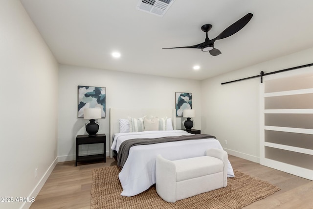 1736 N Ashbrook Cir, Mesa, AZ 85213 - bedroom featuring a barn door, light wood-style flooring, baseboards, a ceiling fan, and recessed lighting
