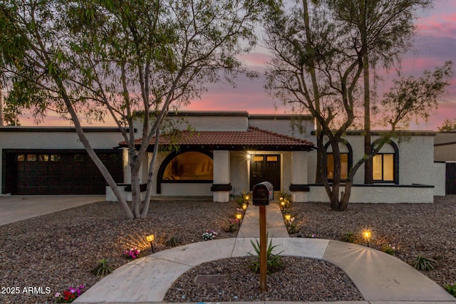 1736 N Ashbrook Cir, Mesa, AZ 85213 - mediterranean / spanish house featuring an attached garage, stucco siding, concrete driveway, and a tile roof