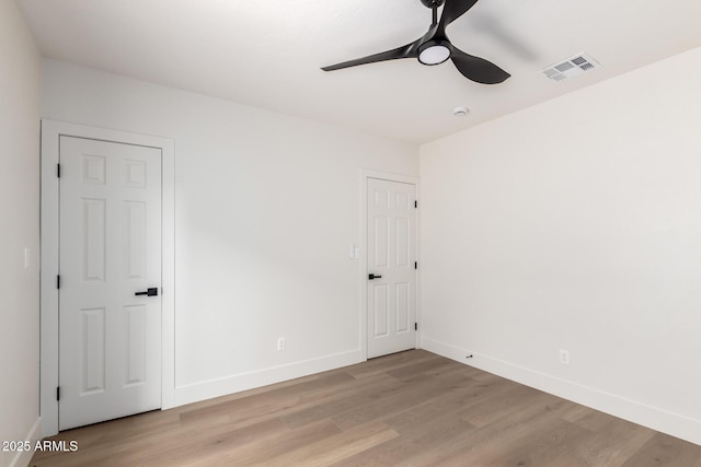 1736 N Ashbrook Cir, Mesa, AZ 85213 - unfurnished bedroom with light wood-type flooring, baseboards, and a ceiling fan