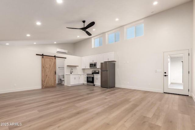 1736 N Ashbrook Cir, Mesa, AZ 85213 - unfurnished living room with a barn door, ceiling fan, high vaulted ceiling, recessed lighting, and an AC wall unit