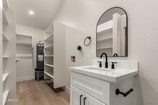 1736 N Ashbrook Cir, Mesa, AZ 85213 - bathroom with electric water heater, wood finished floors, vanity, baseboards, and a textured wall