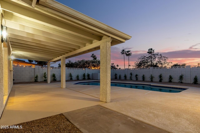 1736 N Ashbrook Cir, Mesa, AZ 85213 - pool at dusk featuring a patio area and a fenced backyard