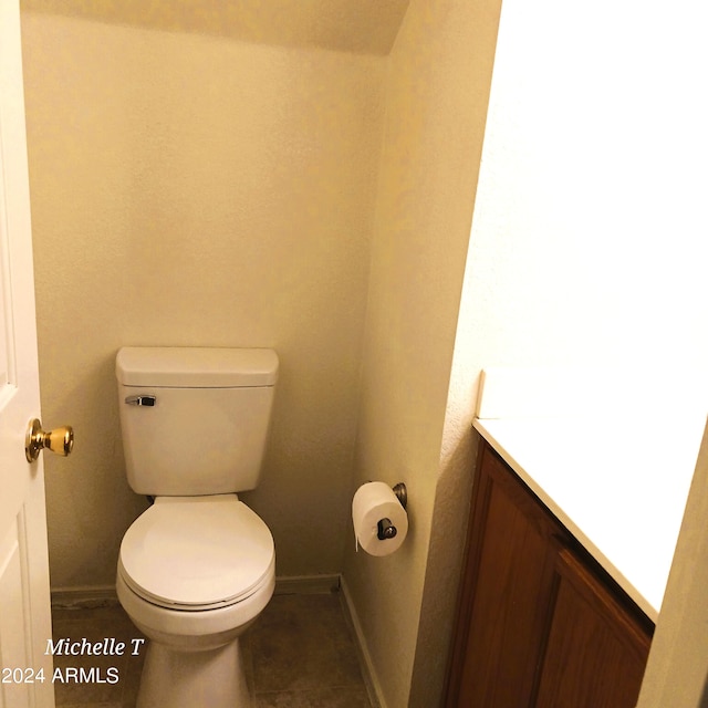 bathroom with vanity, toilet, and tile patterned floors