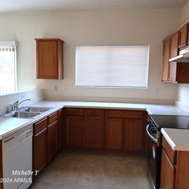 kitchen with sink, white dishwasher, and electric stove