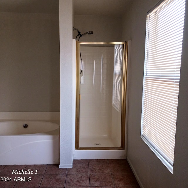 bathroom with independent shower and bath and tile patterned floors