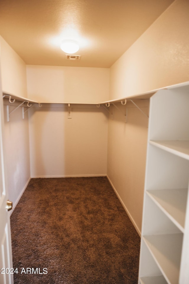 walk in closet with carpet floors and visible vents