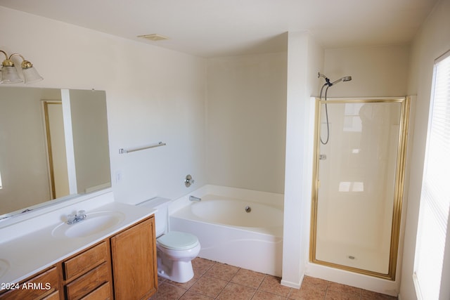 bathroom with a garden tub, toilet, a stall shower, vanity, and tile patterned floors