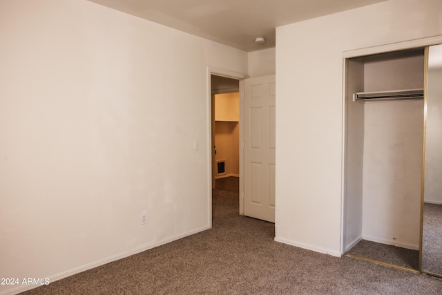 unfurnished bedroom featuring a closet, carpet flooring, and baseboards