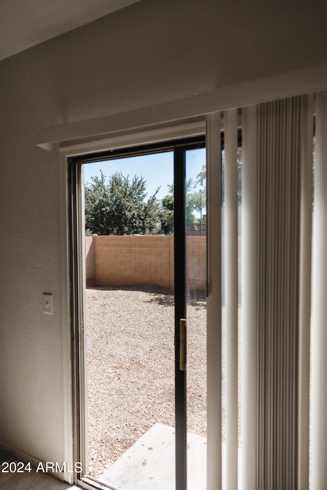 doorway to outside with a wealth of natural light and carpet