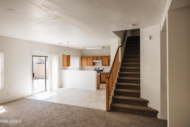 unfurnished living room with light carpet and stairway