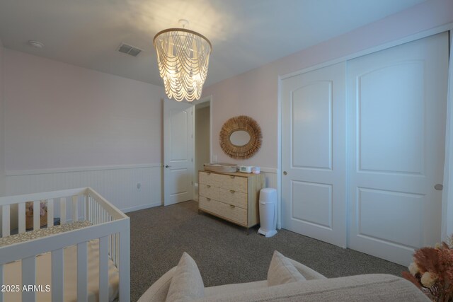 37903 W San Clemente St, Maricopa, AZ 85138 - carpeted bedroom featuring a chandelier, wainscoting, a nursery area, and a closet