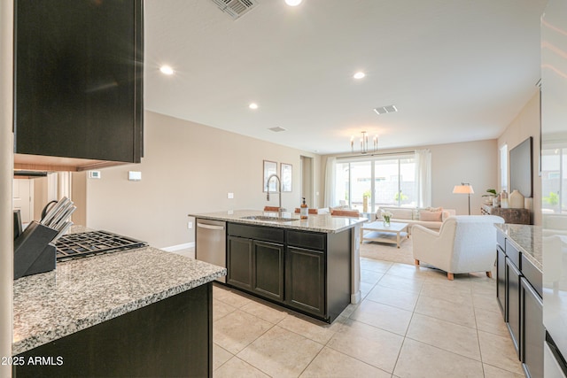 37903 W San Clemente St, Maricopa, AZ 85138 - kitchen with stainless steel dishwasher, a center island with sink, open floor plan, a sink, and recessed lighting