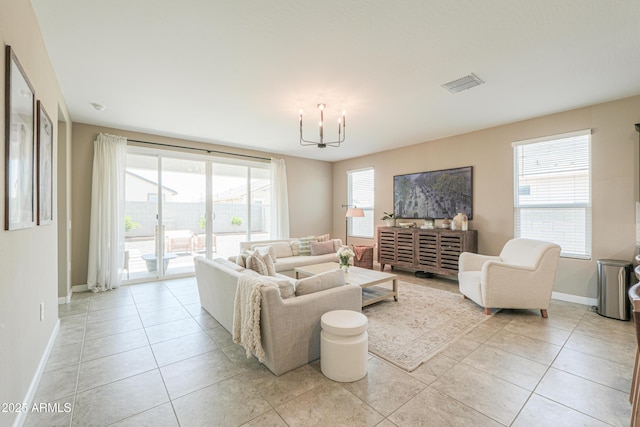 37903 W San Clemente St, Maricopa, AZ 85138 - living room with light tile patterned floors, baseboards, and a chandelier