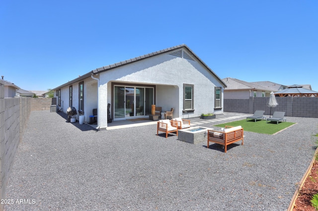 37903 W San Clemente St, Maricopa, AZ 85138 - back of property with stucco siding, a fenced backyard, a patio area, and an outdoor living space with a fire pit