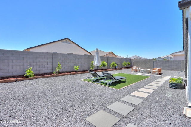 37903 W San Clemente St, Maricopa, AZ 85138 - fenced backyard featuring a patio area and an outdoor hangout area
