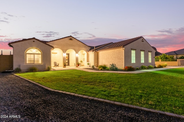 mediterranean / spanish-style home featuring a yard