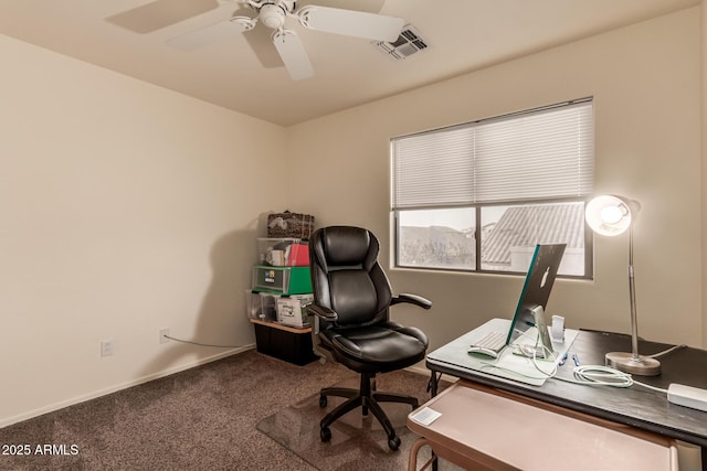 office space with baseboards, carpet floors, visible vents, and a ceiling fan