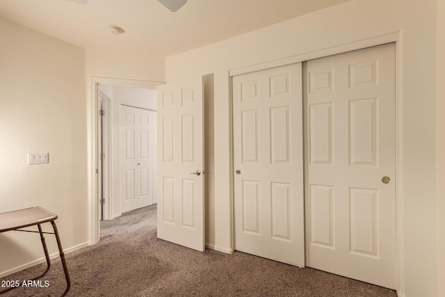 interior space with carpet floors, baseboards, and a closet