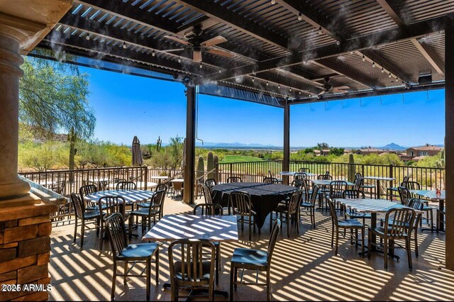view of patio with a ceiling fan and outdoor dining area