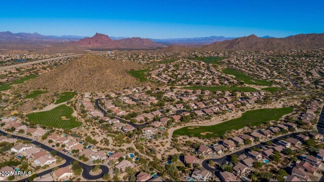 aerial overview of property's location with mountains, nearby suburban area, and a local golf course