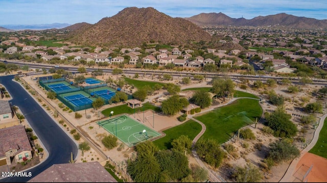 aerial view of property's location featuring a mountainous background and nearby suburban area