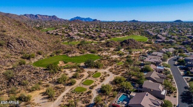 aerial view of residential area with a mountainous background and a local golf course