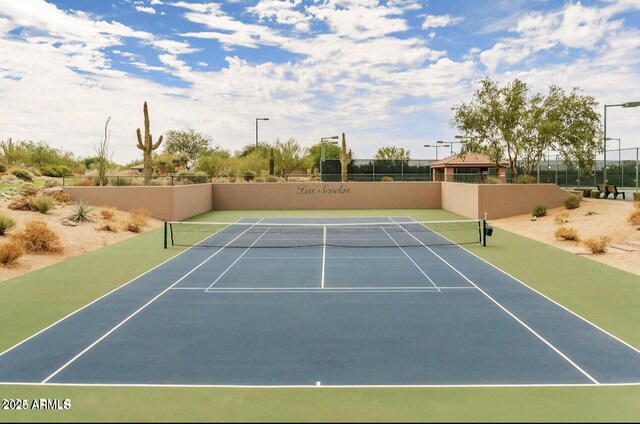 view of tennis court featuring fence