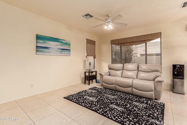 living room with ceiling fan, visible vents, and light tile patterned flooring