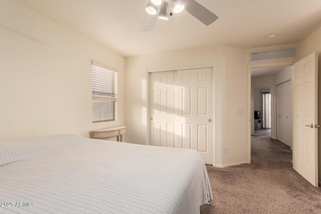 carpeted bedroom featuring ceiling fan, a closet, visible vents, and baseboards