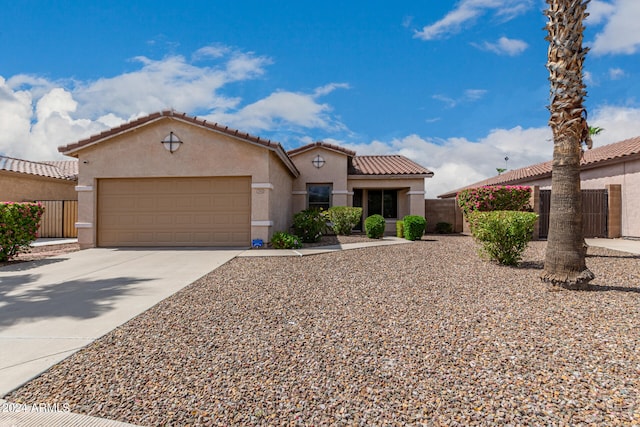 mediterranean / spanish-style home with a garage