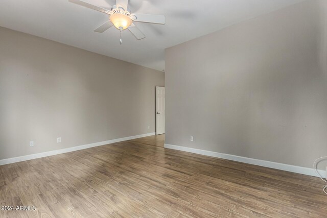 spare room with ceiling fan and hardwood / wood-style flooring