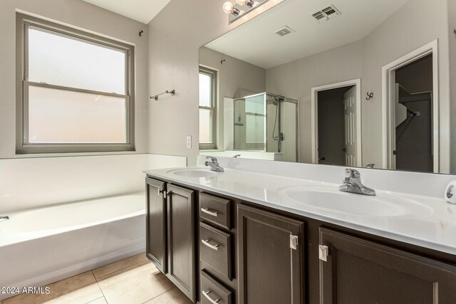 bathroom with shower with separate bathtub, tile patterned flooring, and vanity