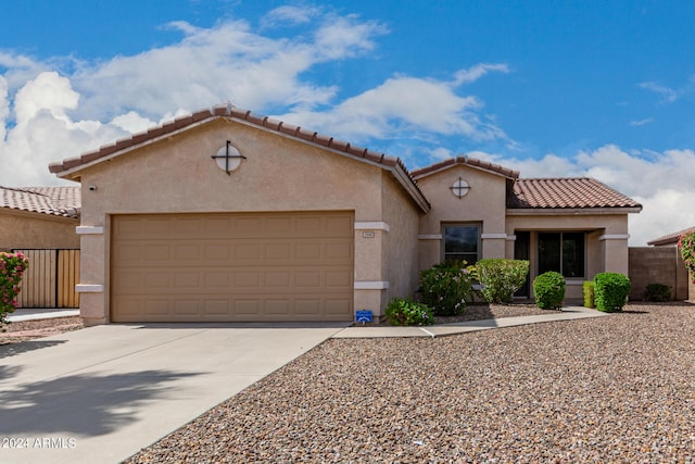 mediterranean / spanish home featuring a garage