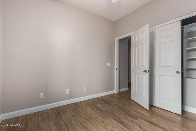 unfurnished bedroom with wood-type flooring and a closet