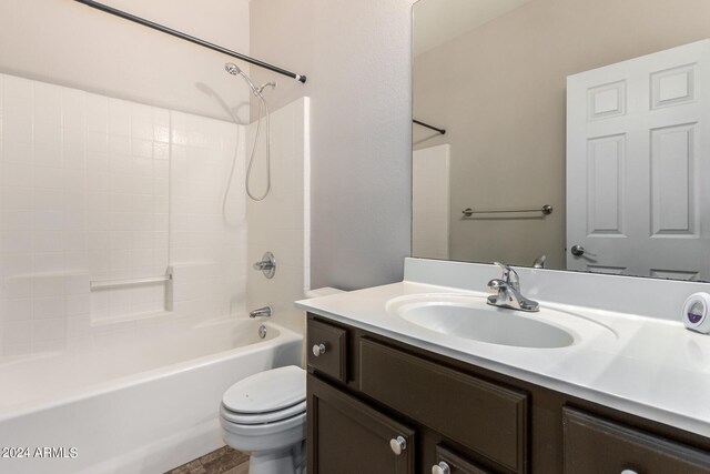 full bathroom with washtub / shower combination, vanity, and toilet