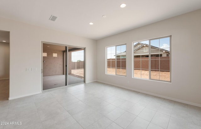 unfurnished bedroom with light tile patterned flooring and access to exterior